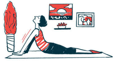 A person does stretching exercises at home on a mat on the floor.